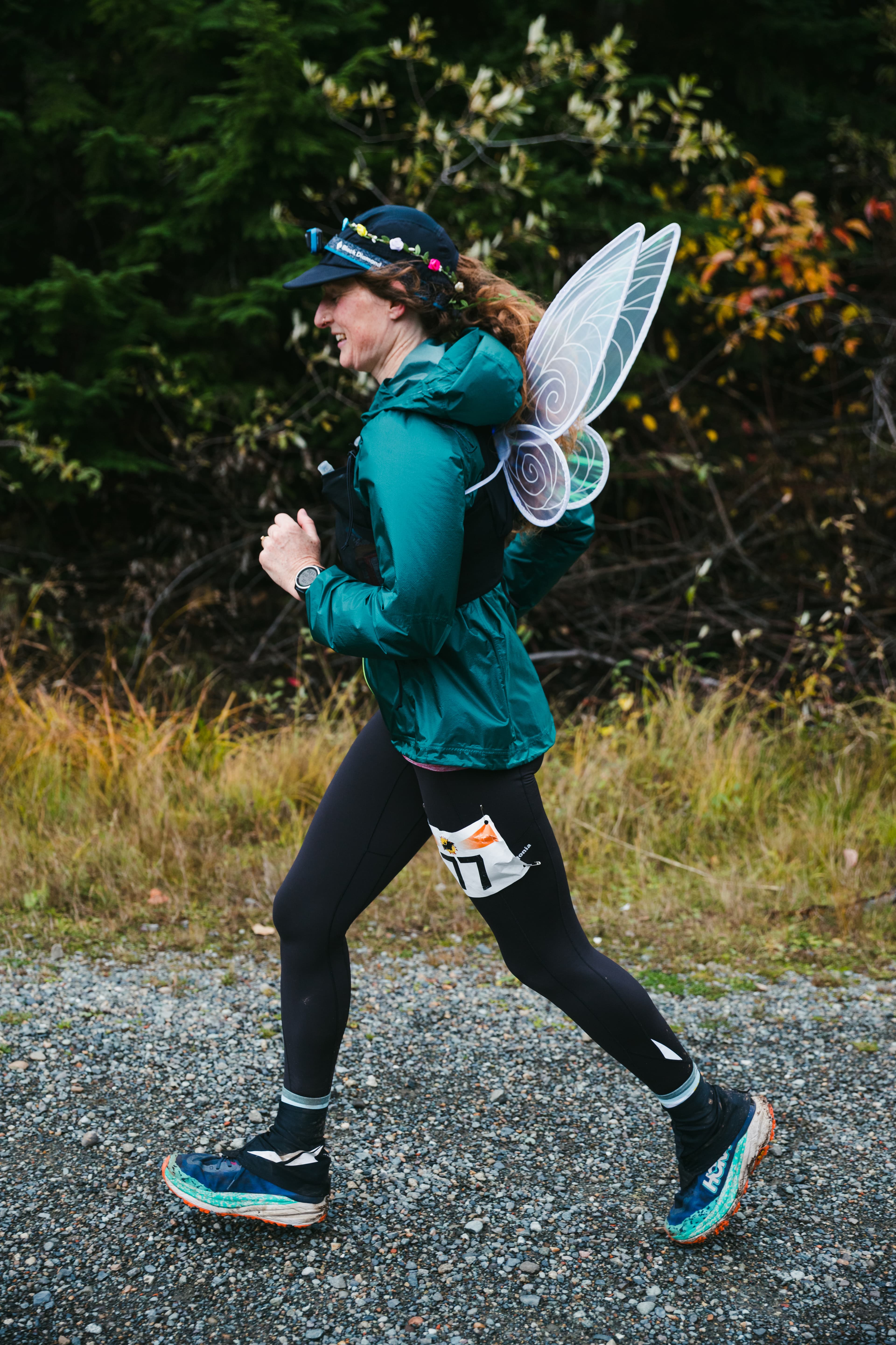 A Hyak Passage runner wearing fairy wings on the gravel trail