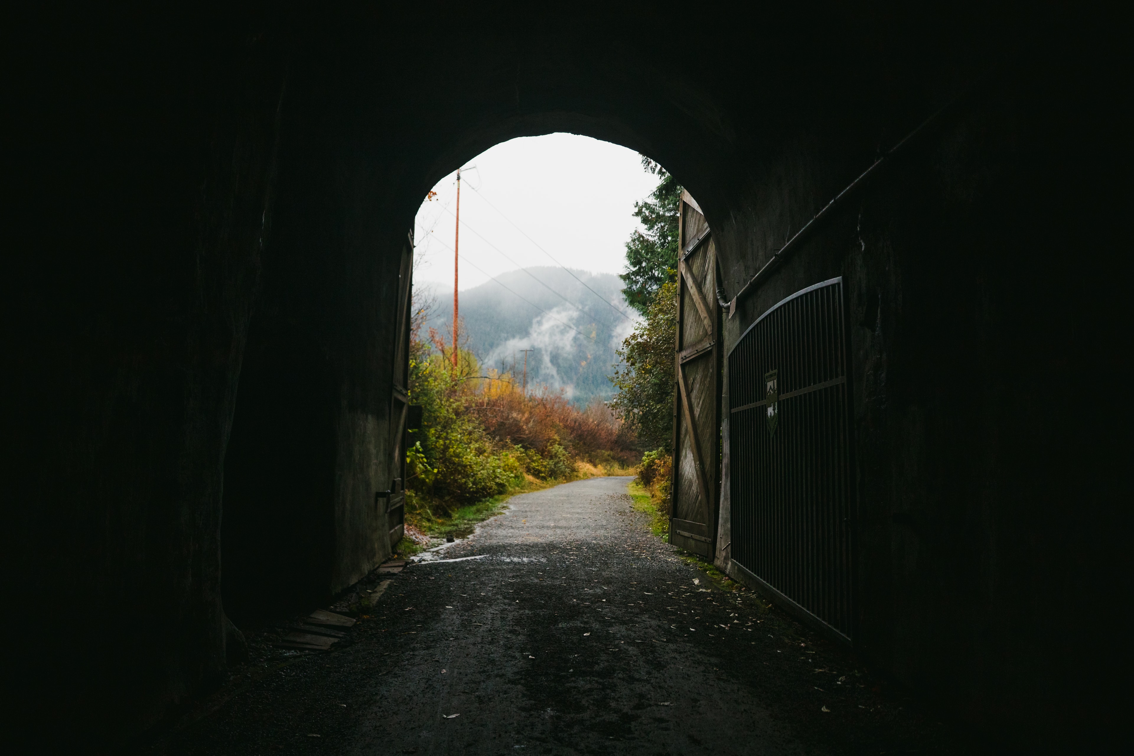 Looking out of the Snoqualmie Tunnel toward the trail and misty mountains
